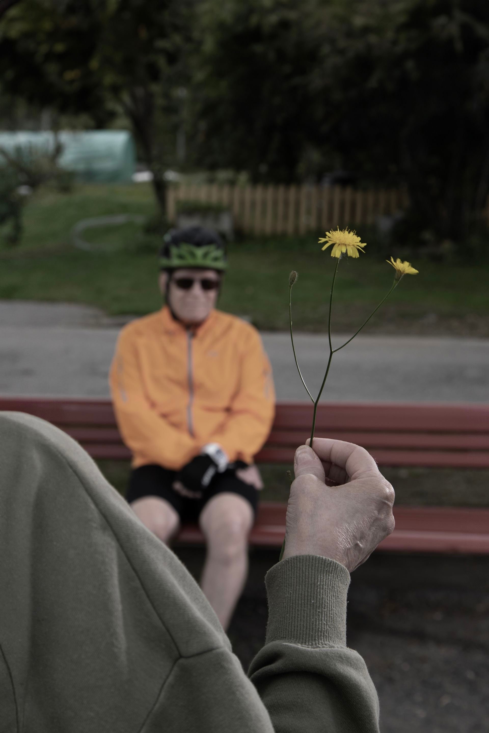 A person sitting on a parck bench.