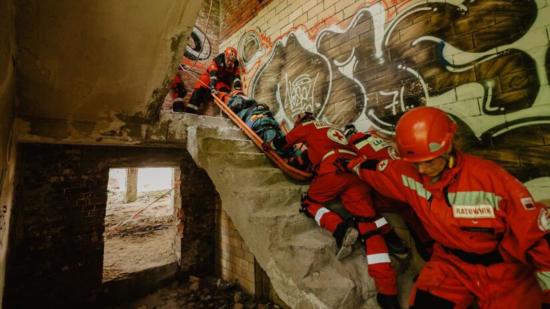 Red Cross volunteers climbing up stairs.