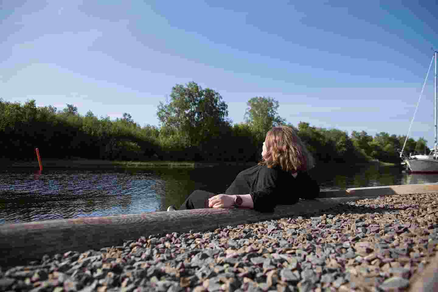 A person sitting by a river.