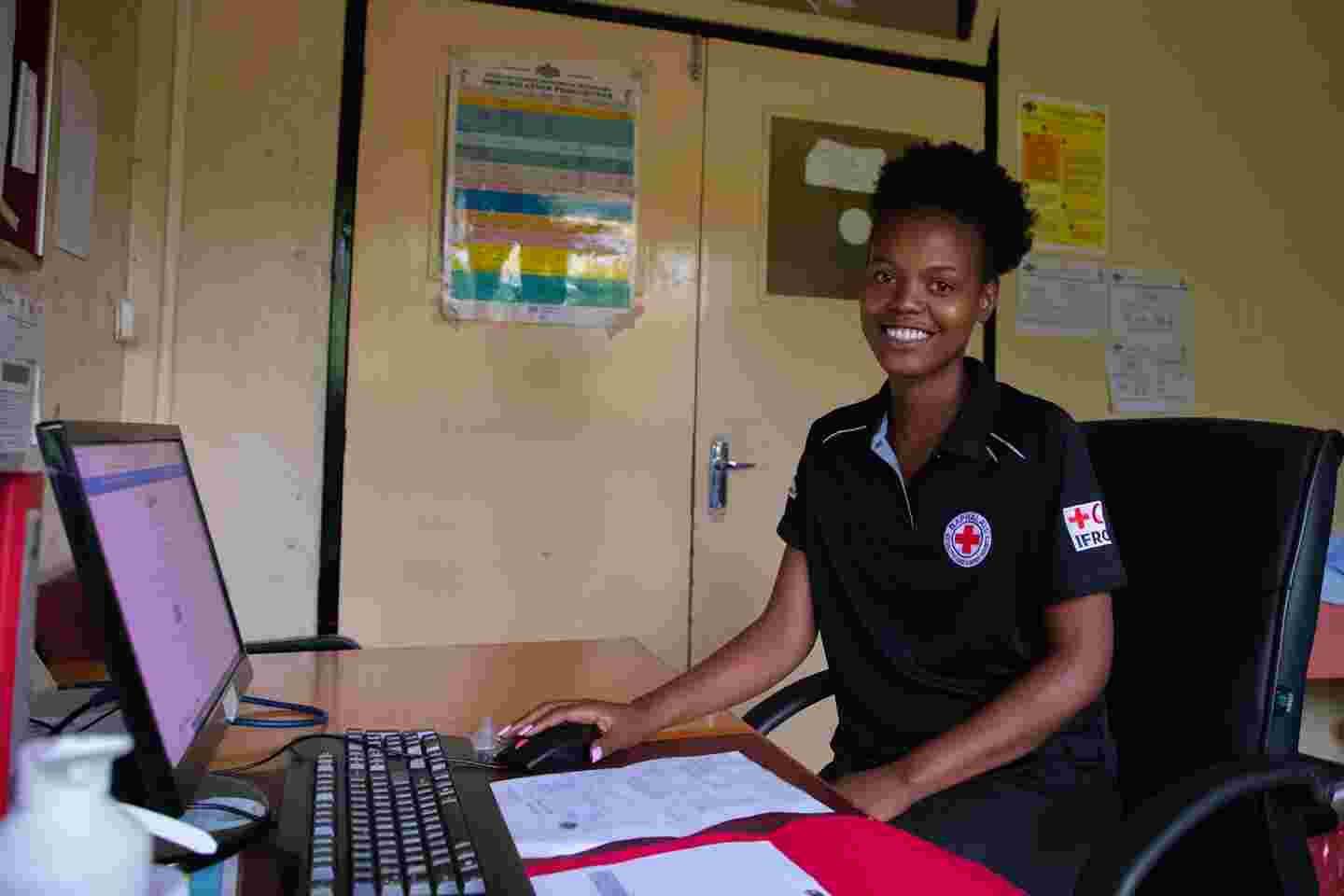 A nurse sitting at a computer.