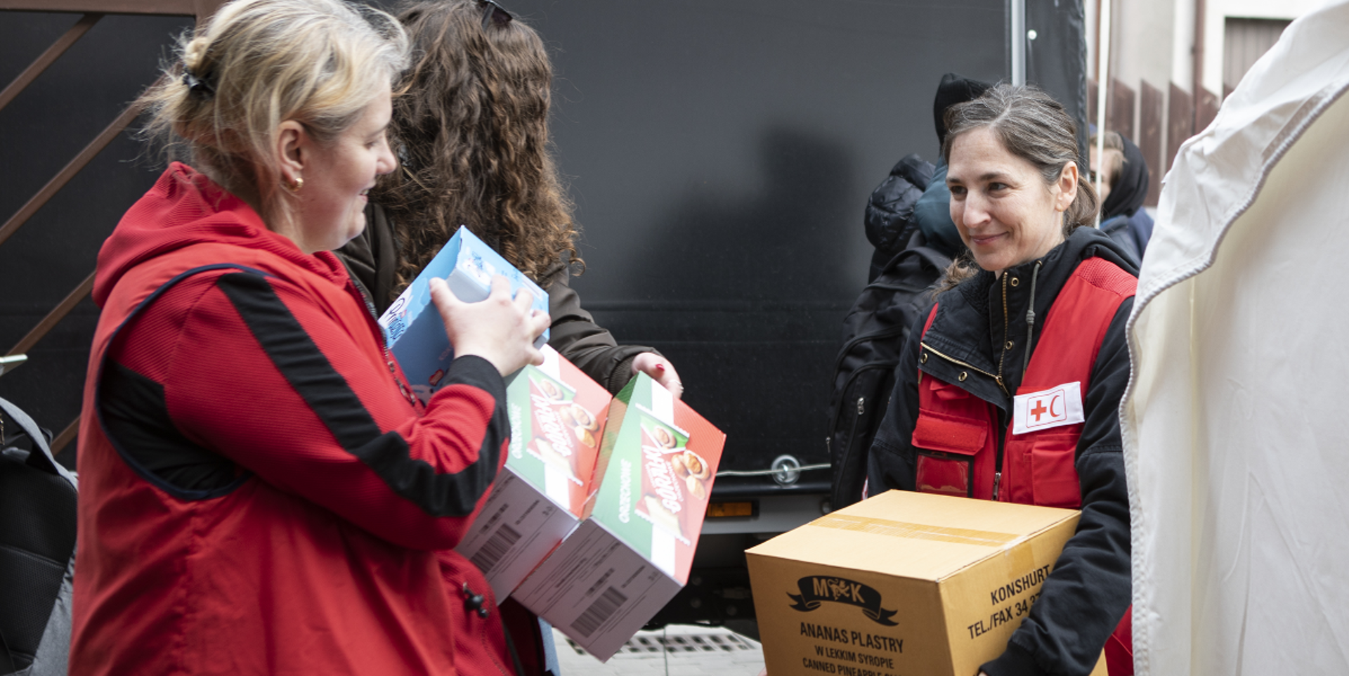 Jenelle from the International Federation of Red Cross and Red Crescent Societies is helping to unload an aid shipment in Warsaw, Poland.