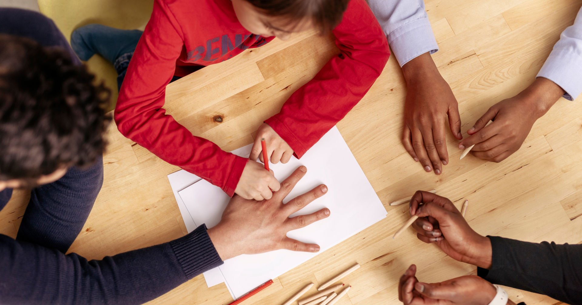 People of different ethnic backgrounds drawing together.