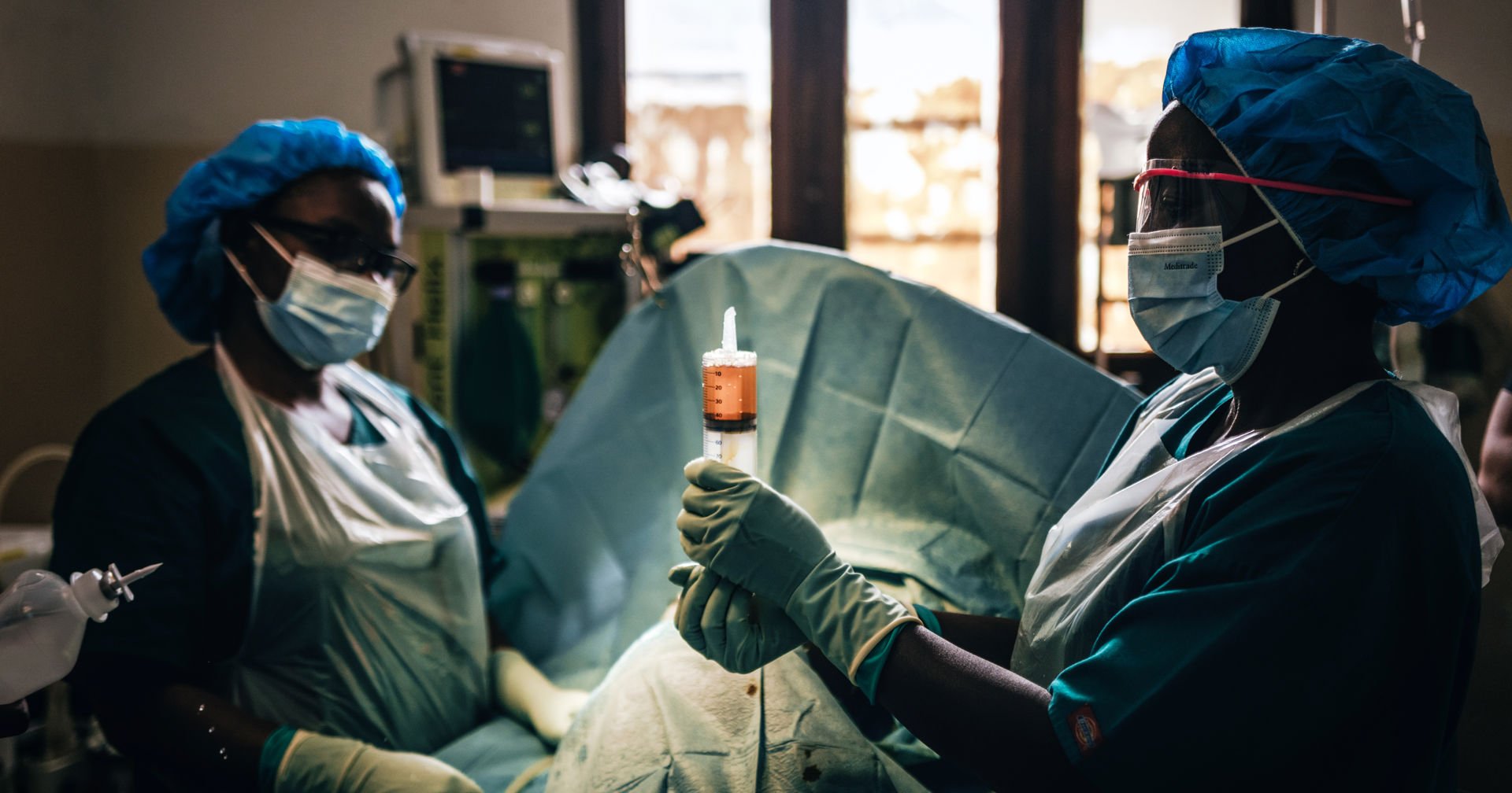 Two nurses from the International Committee of the Red Cross treat an injured person at a hospital in Goma, Democratic Republic of Congo.