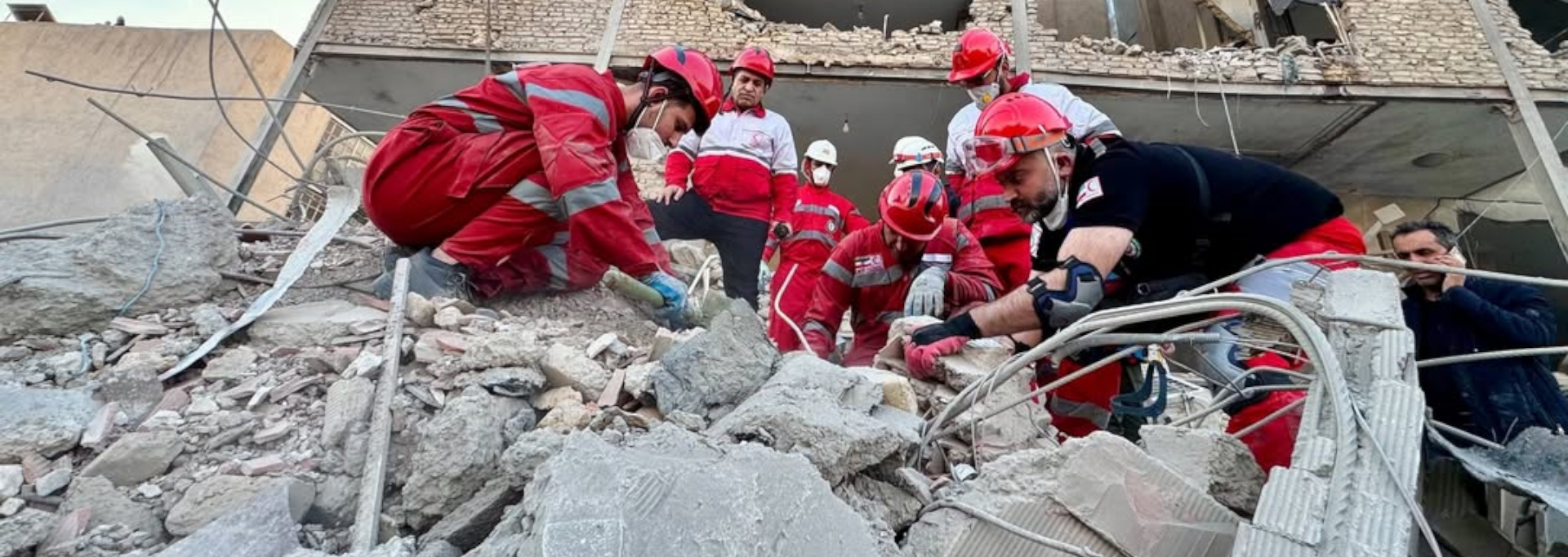 Aid worker feeding nutrient solution to a newborn baby.