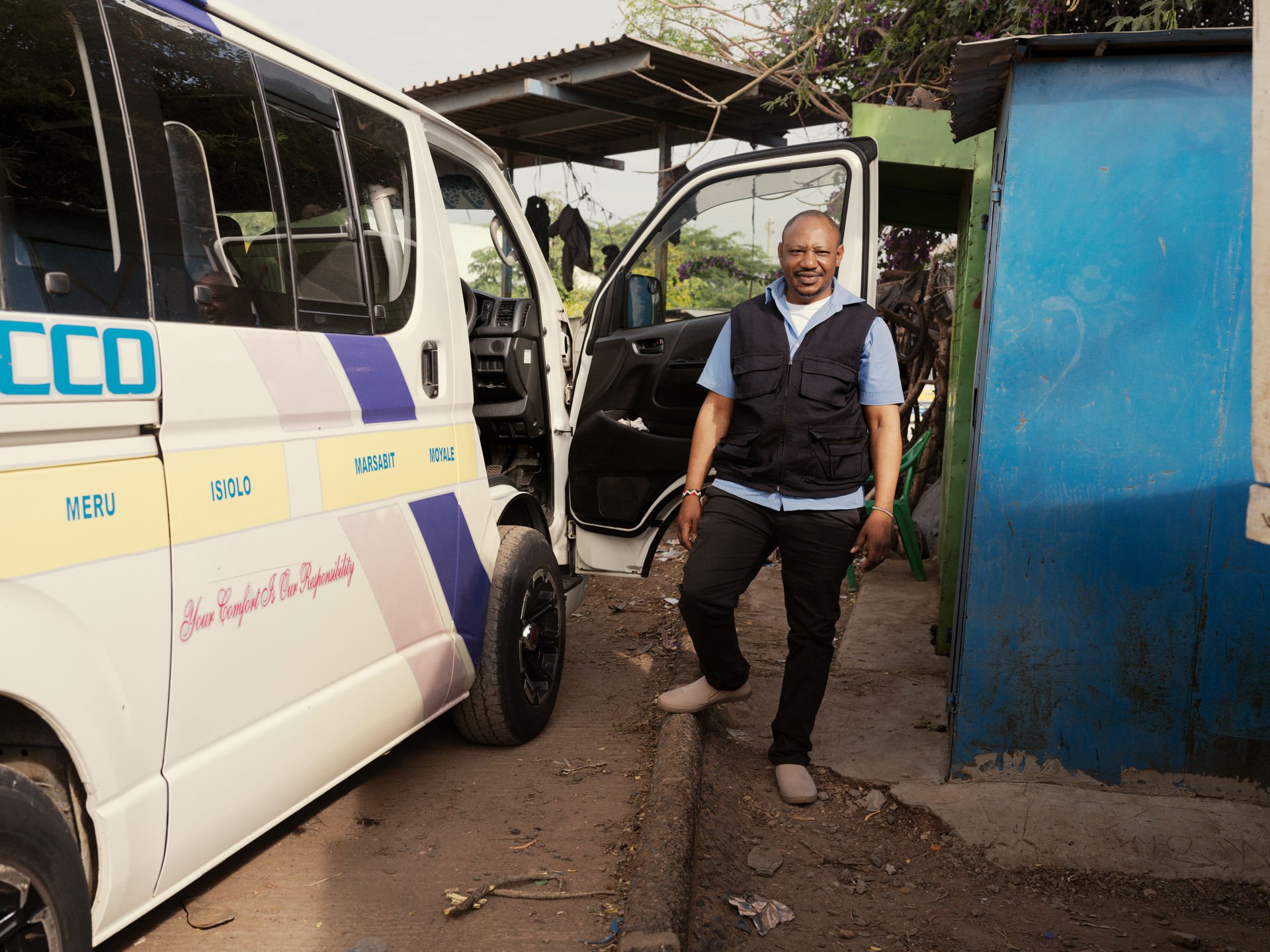 A man standing next to a car.