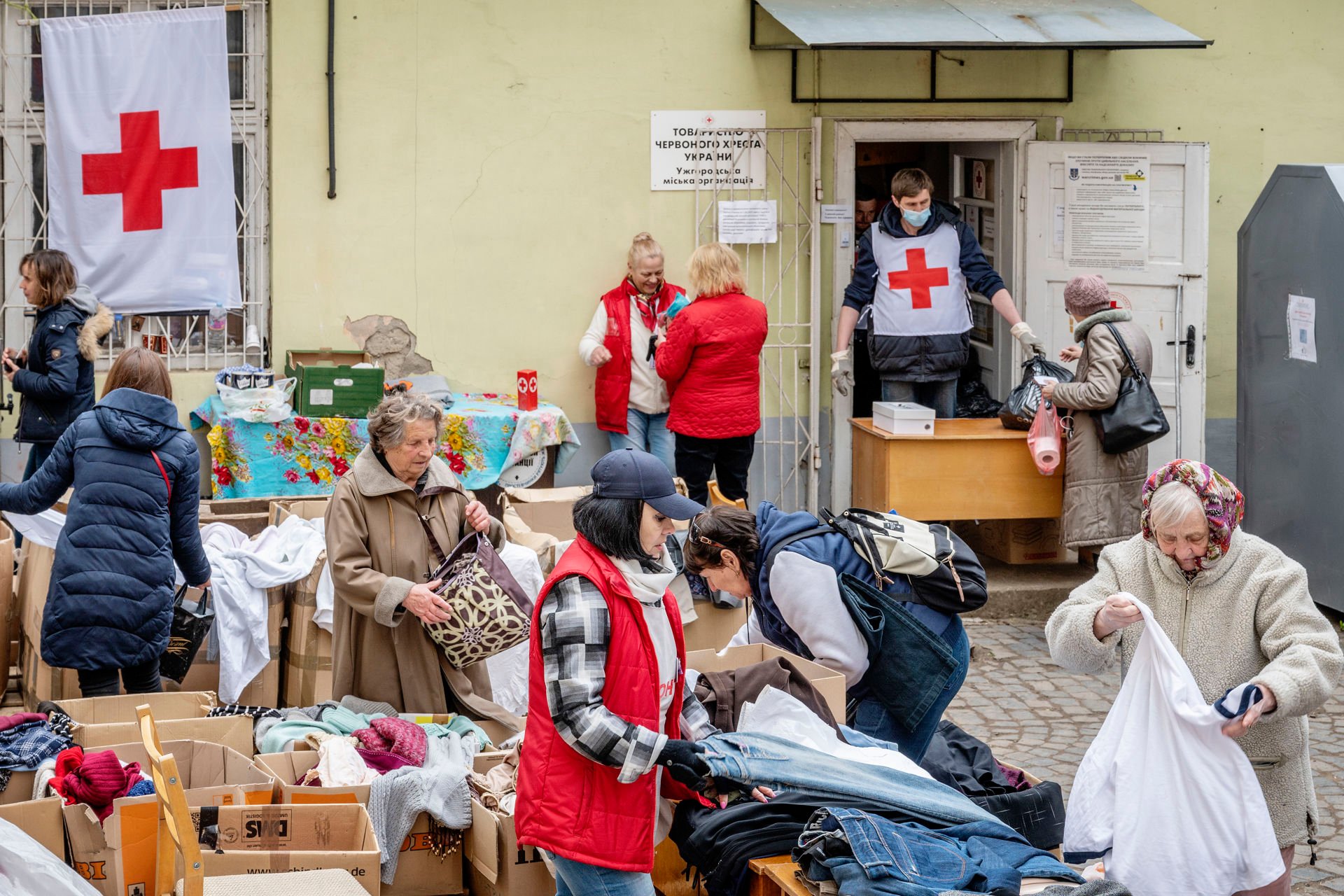 People sorting supplies in a square.