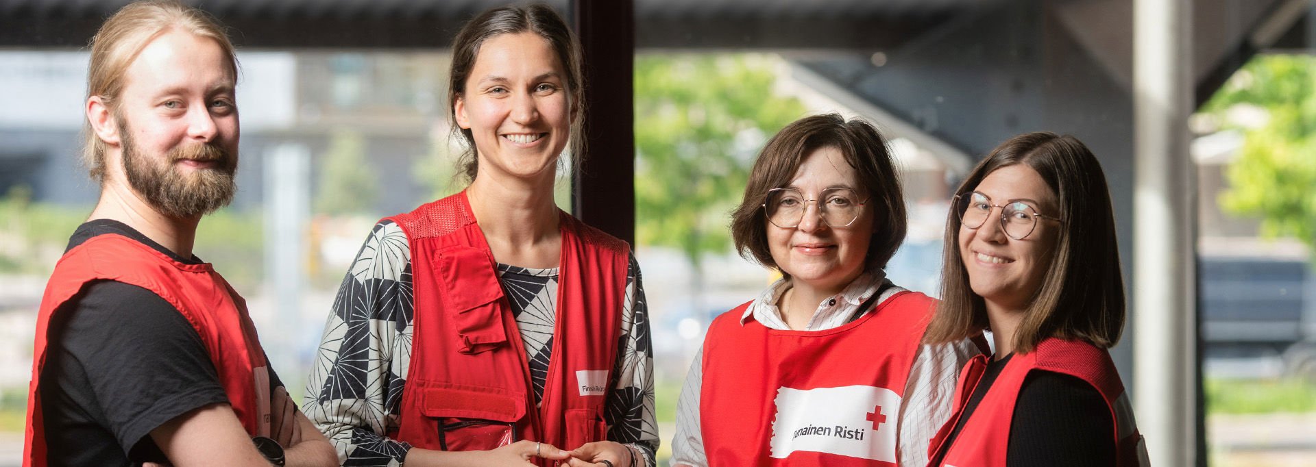 On first aid duty at an outdoor event, a man and a woman wearing Red Cross uniforms walk towards the sunset.